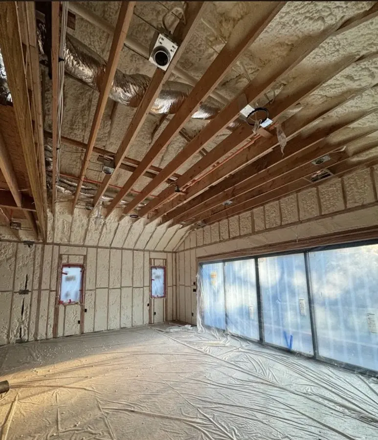 Interior walls and ceiling insulated with spray foam during new construction in Howland Center